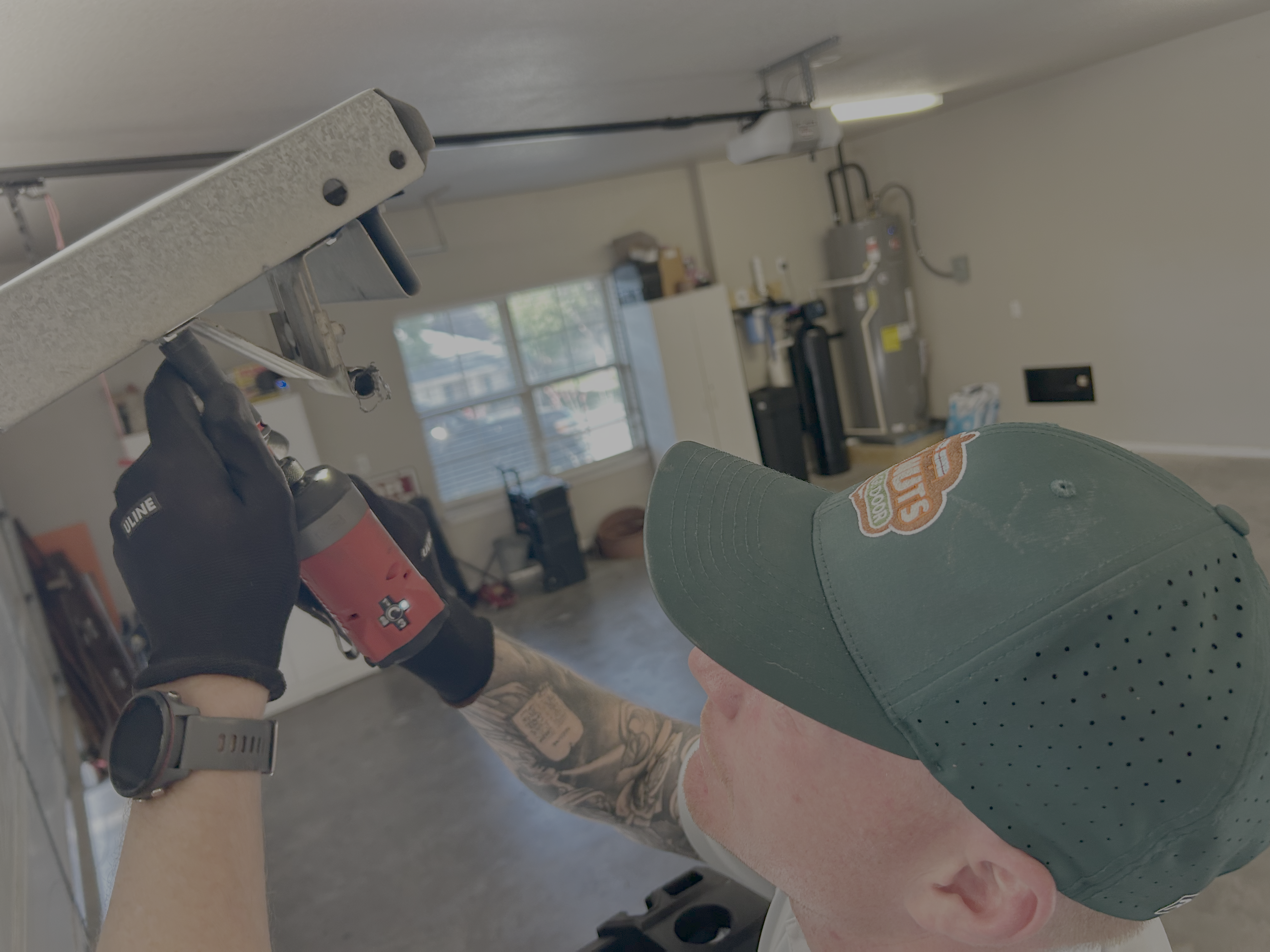 Go Nuts Garage Door technician installing a garage door opener in Granbury, TX