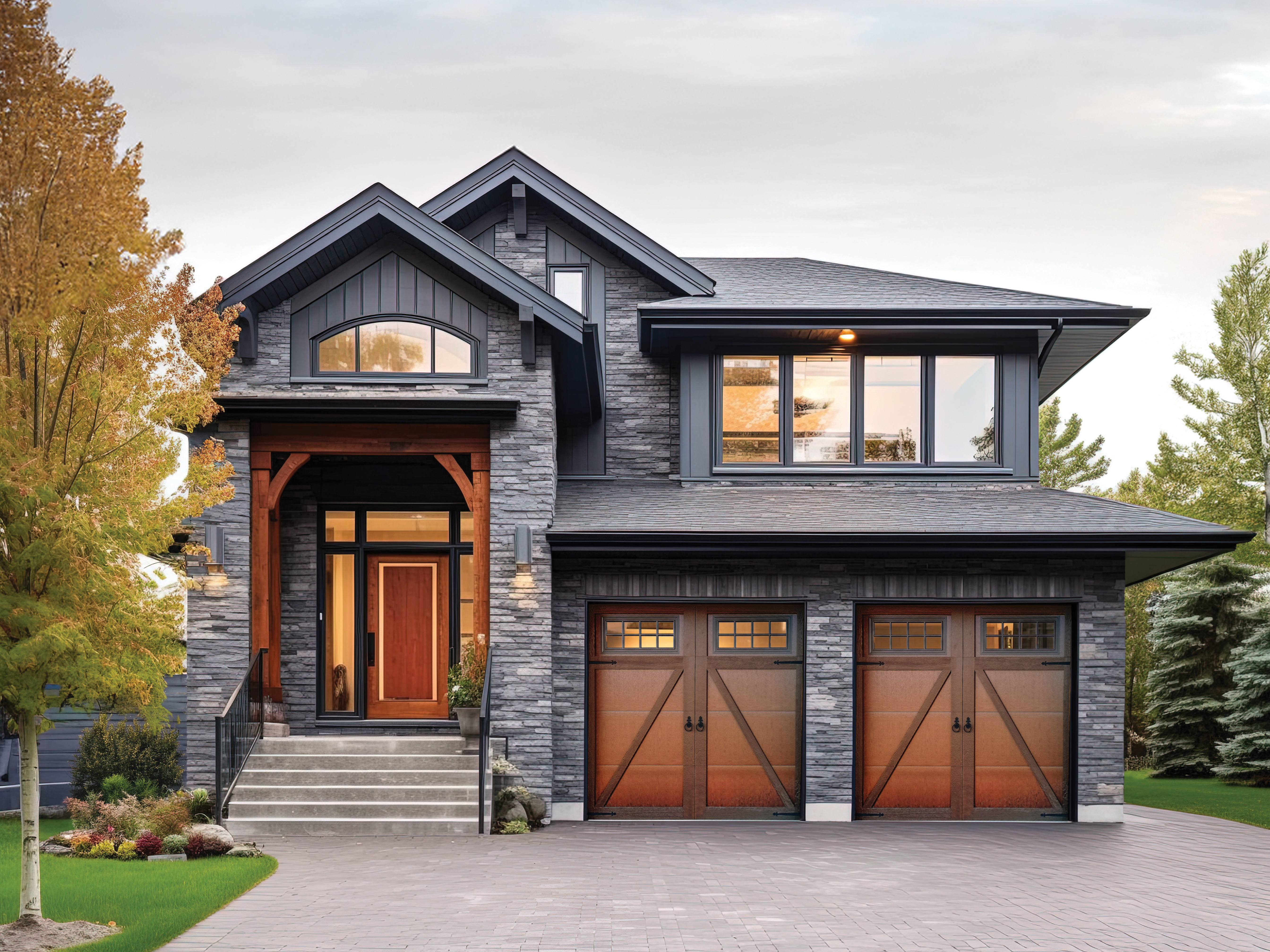 Steel overlay carriage-house garage doors in dark oak finish installed by Go Nuts Garage Door